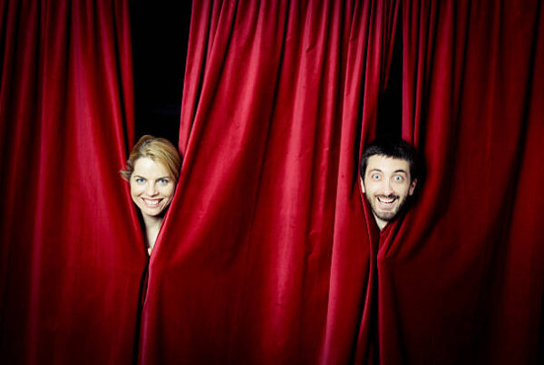 adult acting classes- man and woman peeking out of curtain